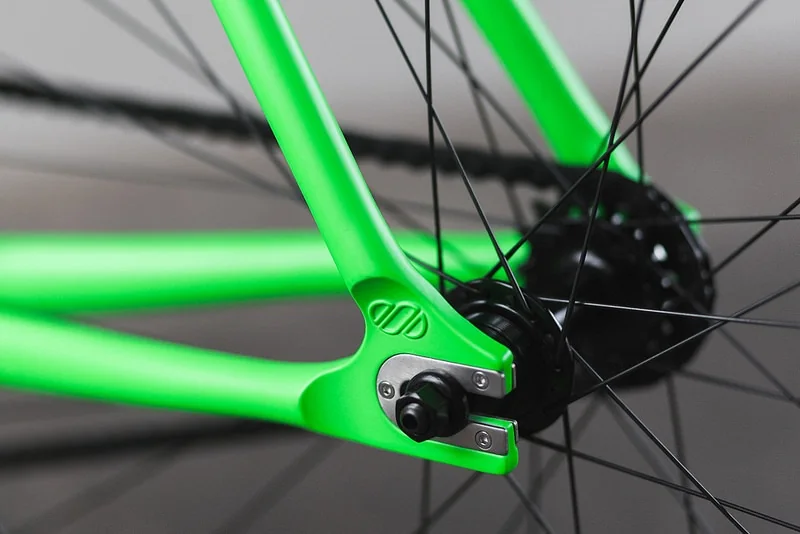Rear wheel hub and dropout of a green bicycle